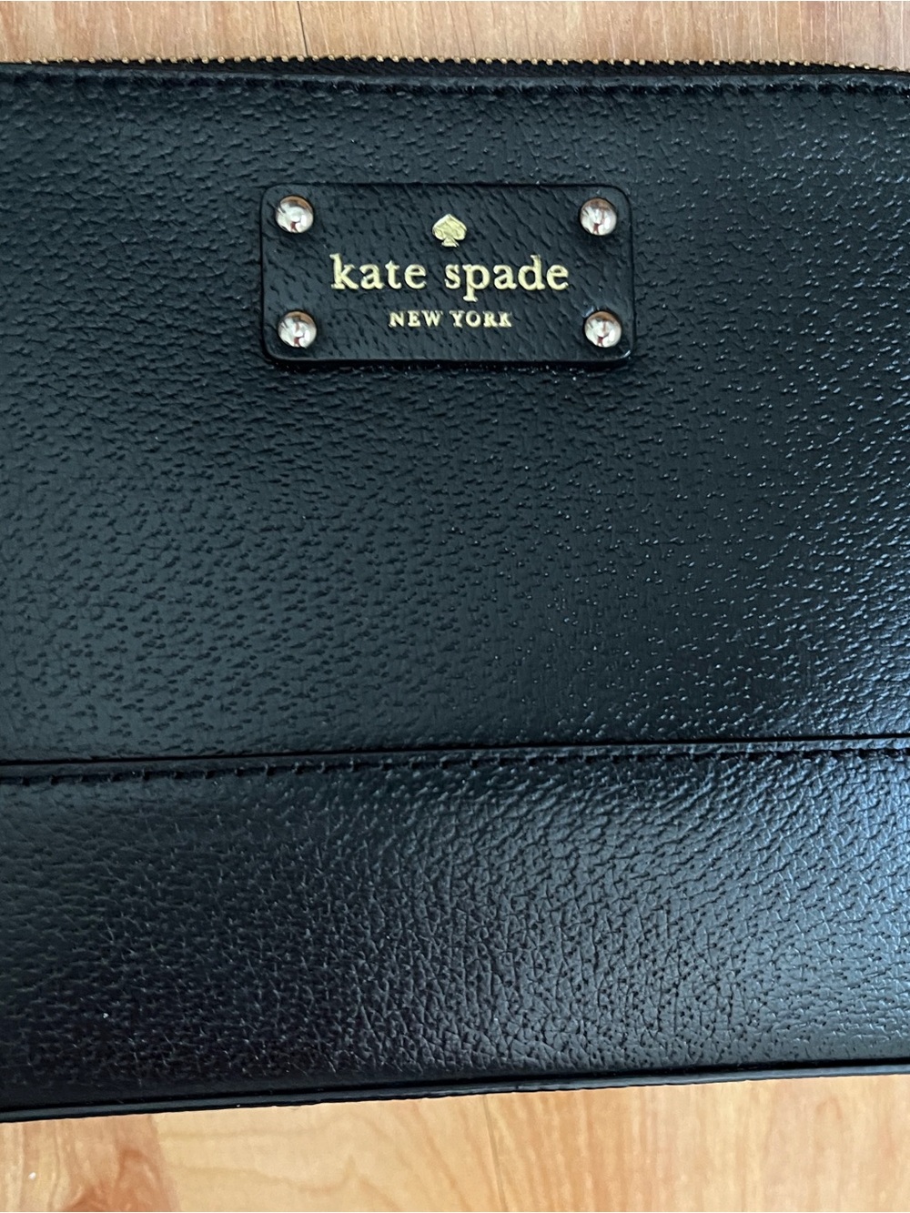 EUC Kate Spade black leather crossbody with gold lettering on logo plate